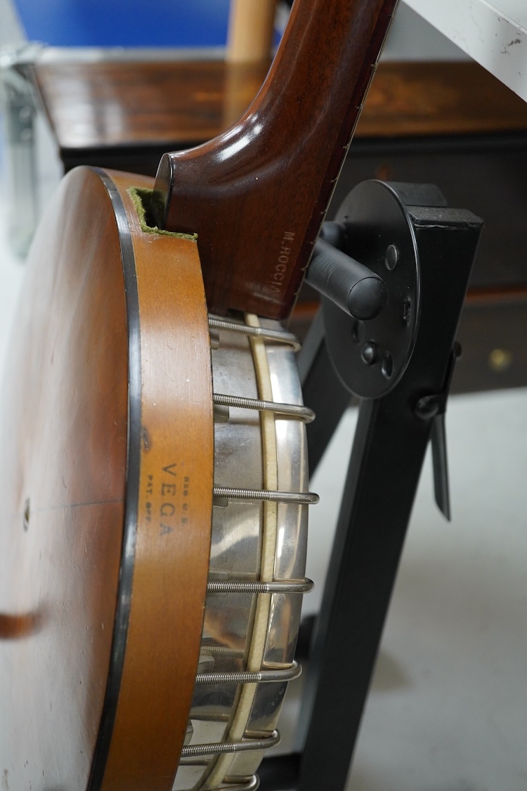 A cased Vega 4-string tenor banjo stamped M. Roccia, steel body with veneered back, the case embossed with; Ronald Quilter, 10, Cadogan Lane, London S.W.1., overall length 82cm